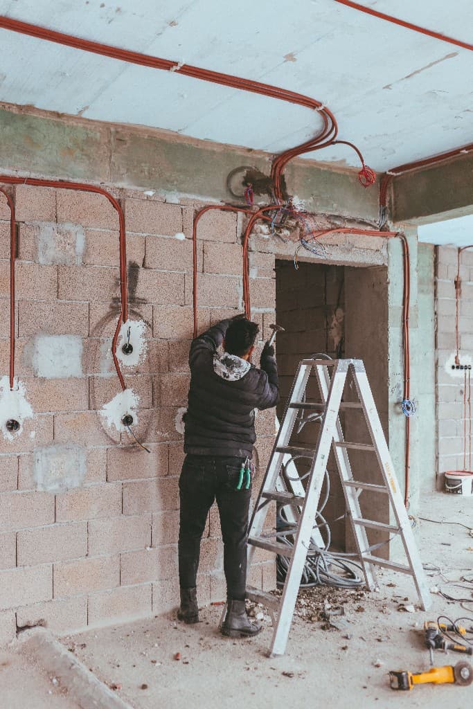Electrician installing new construction conduit and rough-in wiring